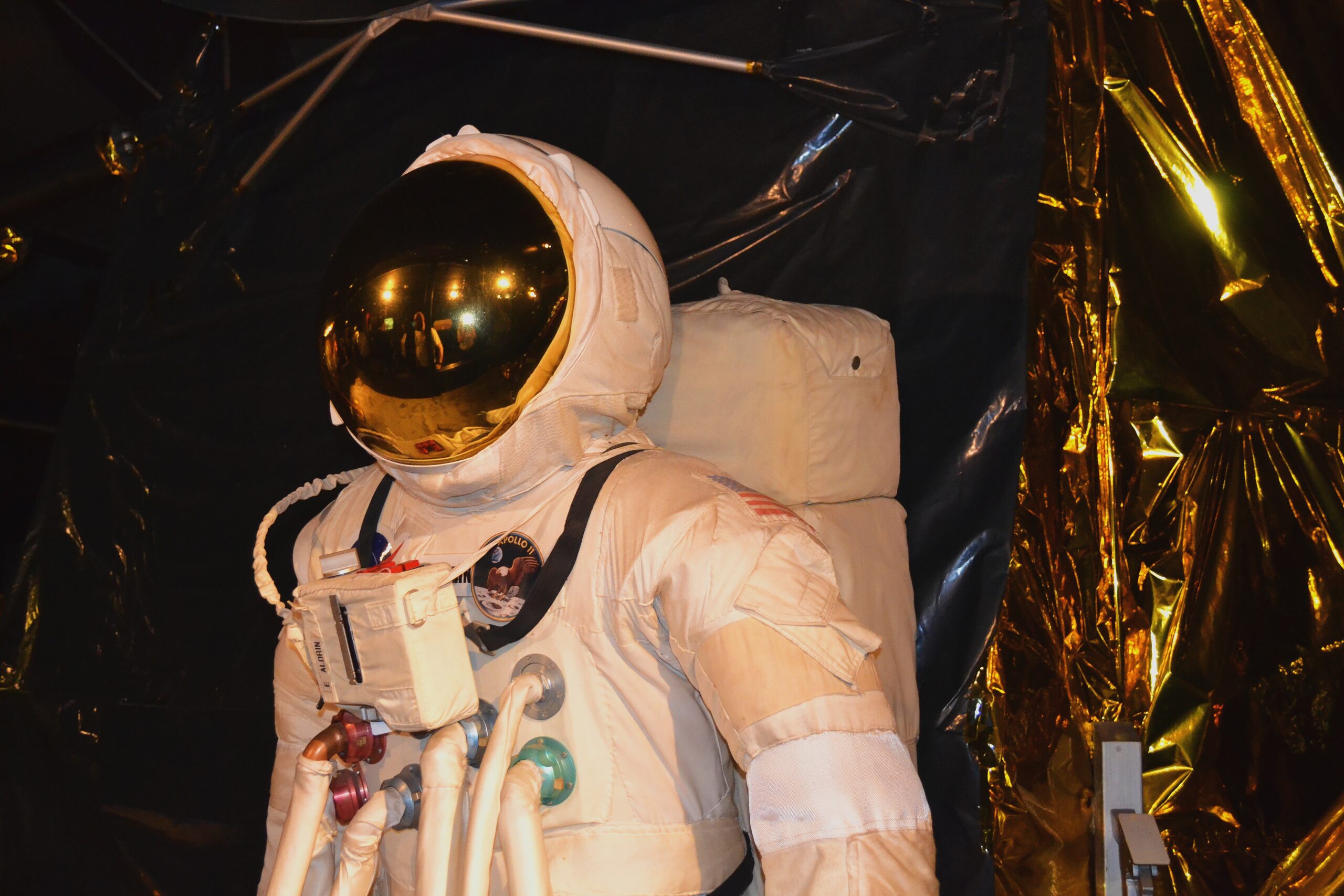 Close-up of an astronaut suit on display, symbolizing the innovative and exploratory support provided by GiftAider to educational and scientific institutions.