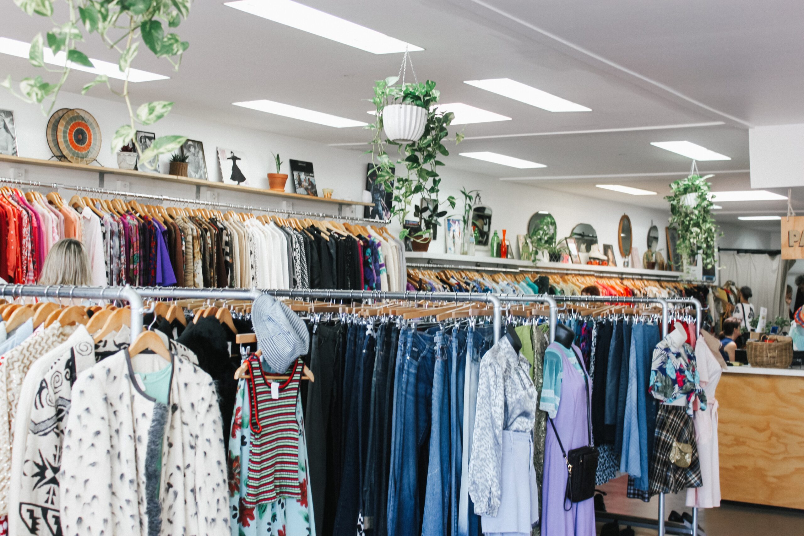 Charity shop with neatly organized clothes and accessories, showcasing the vibrant community support facilitated by GiftAider for efficient Gift Aid claims.